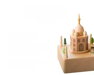 Detailed macro view of the handcrafted wooden music box featuring a rotating castle design