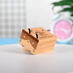 European wooden hand-crank music box with cartoon cat face and Eiffel Tower carving