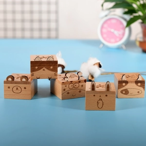 Set of five wooden animal music boxes featuring bear, cat, deer, rabbit, and cow designs