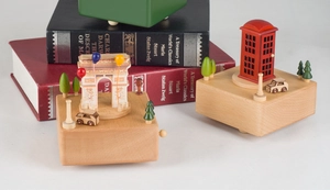 Detailed macro of vintage wooden music box featuring Arc de Triomphe and red phone booth