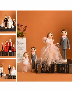 Detail of wooden wedding doll set featuring miniature lace bridal gown and suit outfits