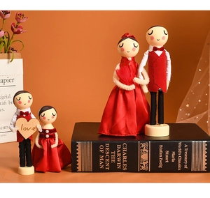Macro view of European wooden wedding dolls set with red velvet outfits and love heart