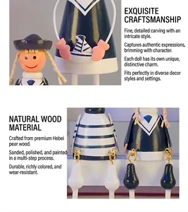 Detailed view of hand-painted wooden nautical dolls with sailboat patterns and sailor outfits