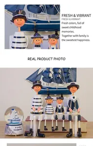 Macro shot of Mediterranean navy sailor wooden figurines set and nautical snow globe