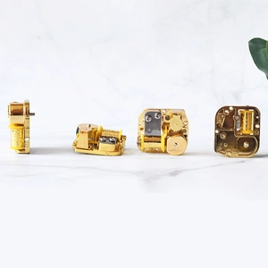 Golden wind-up music box movement with mechanical gears in a four-angle panoramic view