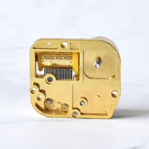 DIY mechanical music box movement in gold finish with rotating drum and comb parts
