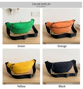 Detail view of nylon crossbody bags in green, orange, yellow and black colors