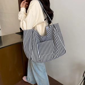 Minimalist black and white striped canvas tote bag with shoulder strap for daily use