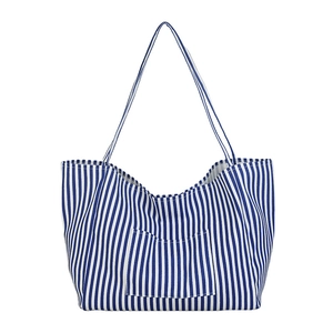 Blue and white striped canvas tote bag with shoulder straps and front pocket for women