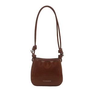 Brown mini crossbody bag in shiny faux leather with knotted strap and silver hardware