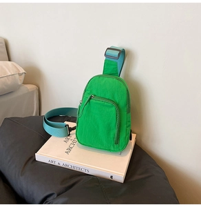 Detail of light green sports chest bag with durable nylon texture and blue adjustable strap