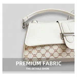 Detail of white half-moon shoulder bag with brown vintage pattern and silver buckle