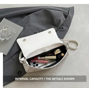 Internal capacity view of beige crossbody bag with textured print showing daily essentials