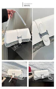 Close-up of white minimalist baguette bag featuring a silver H-buckle and monogram pattern