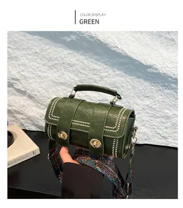 Detail of green Boston bag featuring silver studs and bohemian colorful wide strap