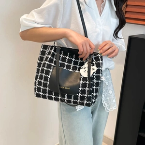 Schicke schwarz-weiße Hahnentritt-Woll-Tote-Bag mit Ledertasche und Katzenanhänger