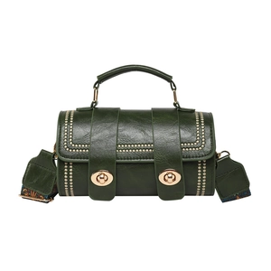 Retro dark green cylindrical crossbody bag with gold hardware and studded details