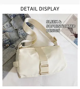 Detail view of beige nylon crossbody bag featuring wide shoulder strap and plastic buckle