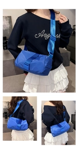 Detailed view of a blue nylon crossbody bag with adjustable strap and sleek design