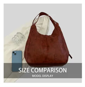 Detailed texture of a brown vintage tote bag next to a smartphone for size reference