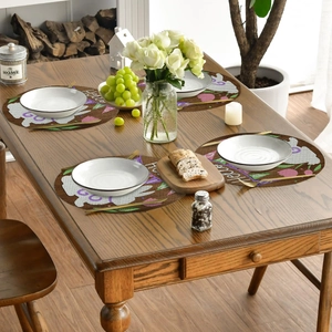 Detailed view of four Easter rabbit linen placemats with floral eggs and Hello text