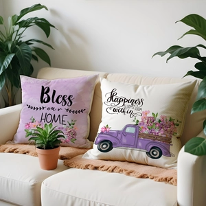 Set of two linen pillow covers with floral prints and slogans on a cozy home sofa