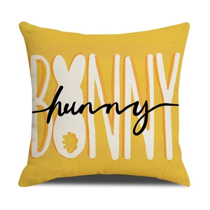 Yellow square pillow with BUNNY letters and rabbit print on white background