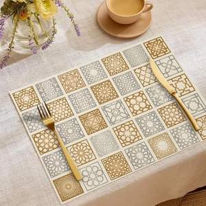 Linen placemat with Middle Eastern geometric patterns on a dining table with gold cutlery