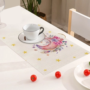 Detail of linen placemat with watercolor moon and floral print for festive dining decor