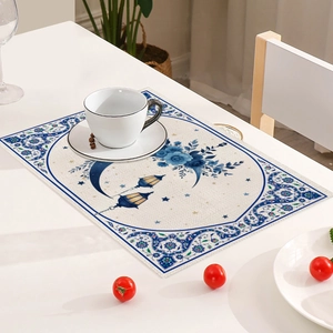 Close-up of linen table mat featuring blue moon and floral motifs for Middle East decor