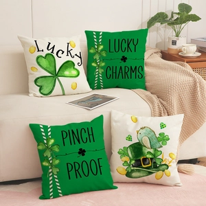 Set of 4 St. Patrick's Day clover and lucky charm throw pillow covers on a cozy sofa