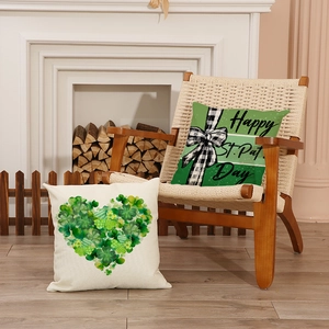 St. Patrick's Day pillow covers with green clover heart and festive bow on a cozy chair