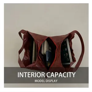 Detailed interior of red-brown leather tote bag showing large capacity and compartments