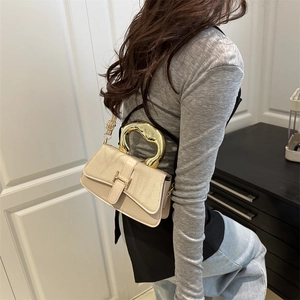 Chic beige structured shoulder bag with a stylish gold circular metal handle for women