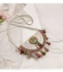 Detail of bohemian saddle bag featuring colorful fringe tassels and ethnic woven patterns