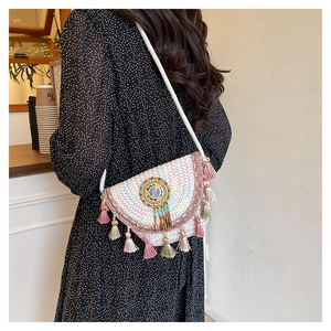 Side view of ethnic bohemian crossbody bag with colorful tassels and bead embroidery