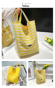 Detailed close-up of yellow and white striped canvas tote bag with leather handmade tag