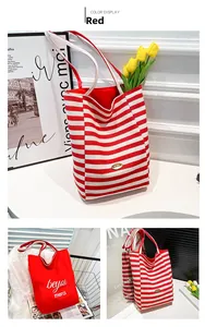 Close-up of red striped canvas tote with handmade tag and beyou merci printed bag