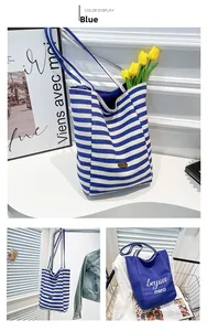 Detail of blue striped canvas tote bag with contrast design and BeYou Merci print