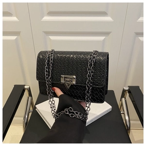 Close-up of black stone pattern crossbody bag with textured finish and silver chain strap