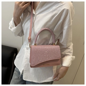 Pink glitter mini crossbody bag detail showing sparkly sequins and miss.mini logo