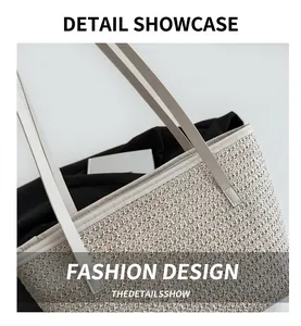 Detailed close-up of woven cream straw tote bag showing fine texture and white strap