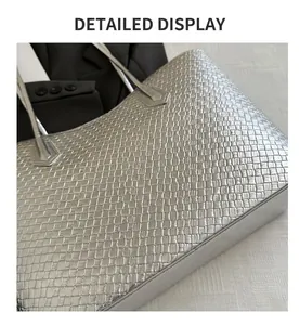 Macro shot of silver woven tote bag texture with precise checkerboard pattern and stitching
