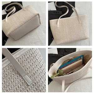 Detail of cream woven tote bag showing reinforced base and cross-stitch texture