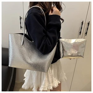 Silver woven texture tote bag and matching zipper pouch set shown on model shoulder
