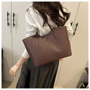 Close-up of a large coffee brown woven tote bag with classic checkerboard pattern