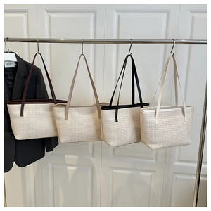 Detail showing four woven tote bags in brown, beige, black, and white colors with slim straps