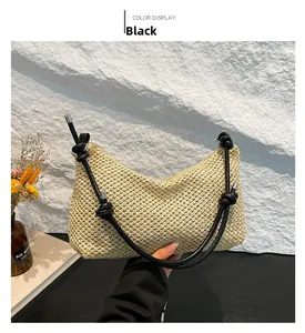 U-shaped beige paper rope woven bag with black knotted shoulder strap detail