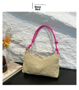 Detail of hand-woven straw tote with vibrant magenta shoulder straps and knot design