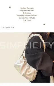 Detail of floral jacquard embroidery and pleated scrunchie shoulder strap on beige bag